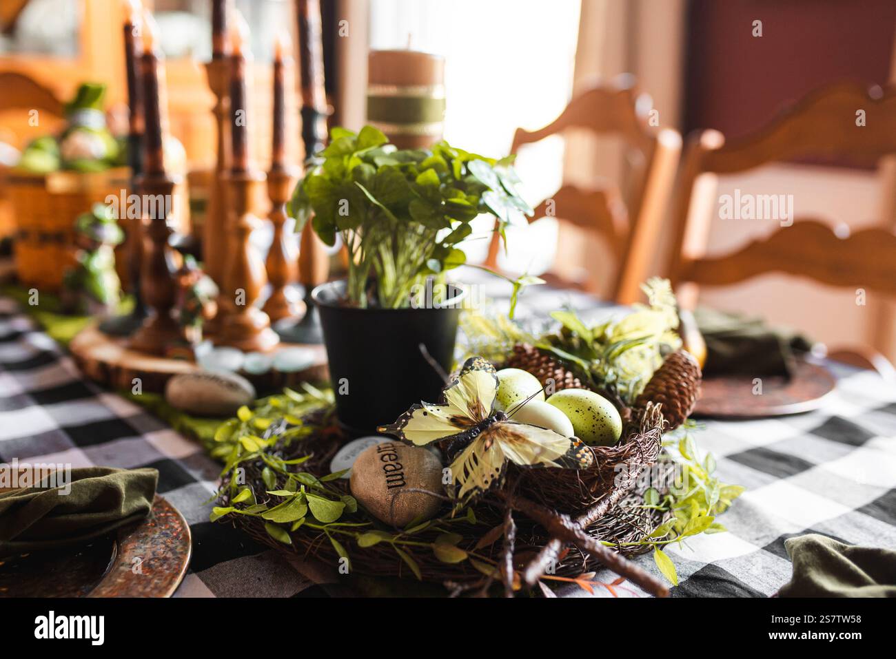 Rustic table setting with greenery and Easter decor. Stock Photo