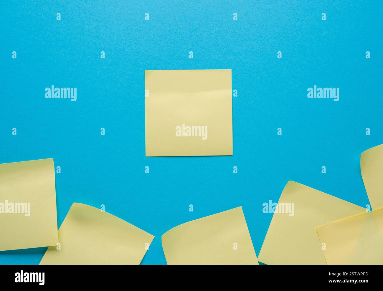 blank yellow sticky note on a blue background Stock Photo