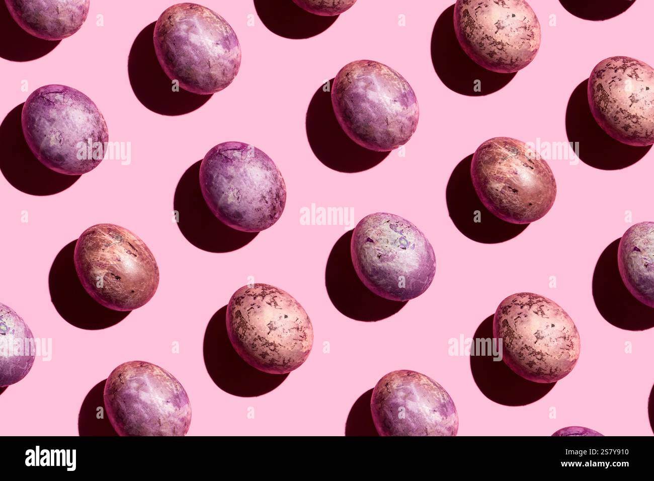 Easter pattern. Painted eggs on pink background. Hard light, hard shadows. Design pattern Stock Photo