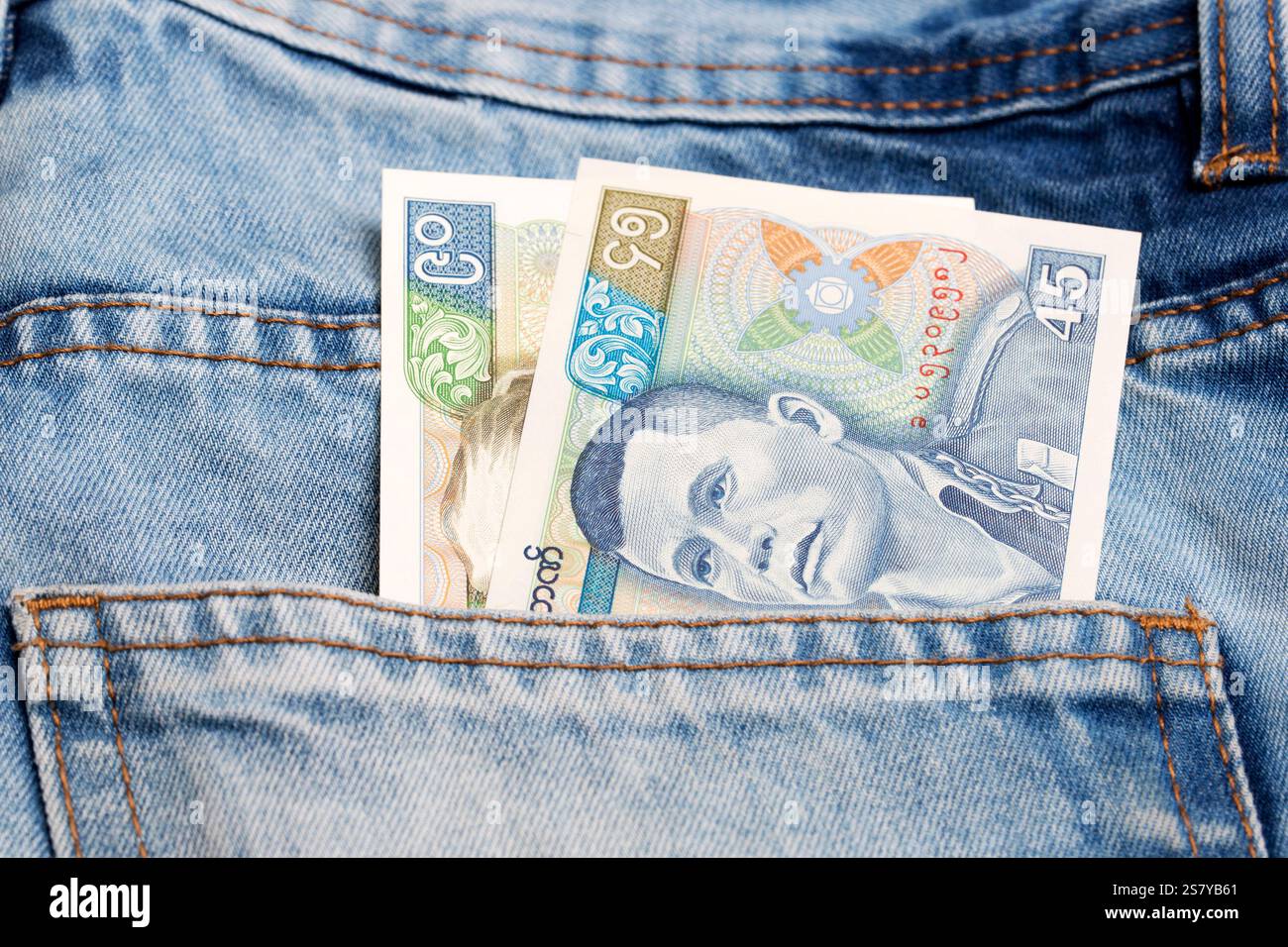 Old Myanmar money - kyat in the pocket of blue jeans Stock Photo