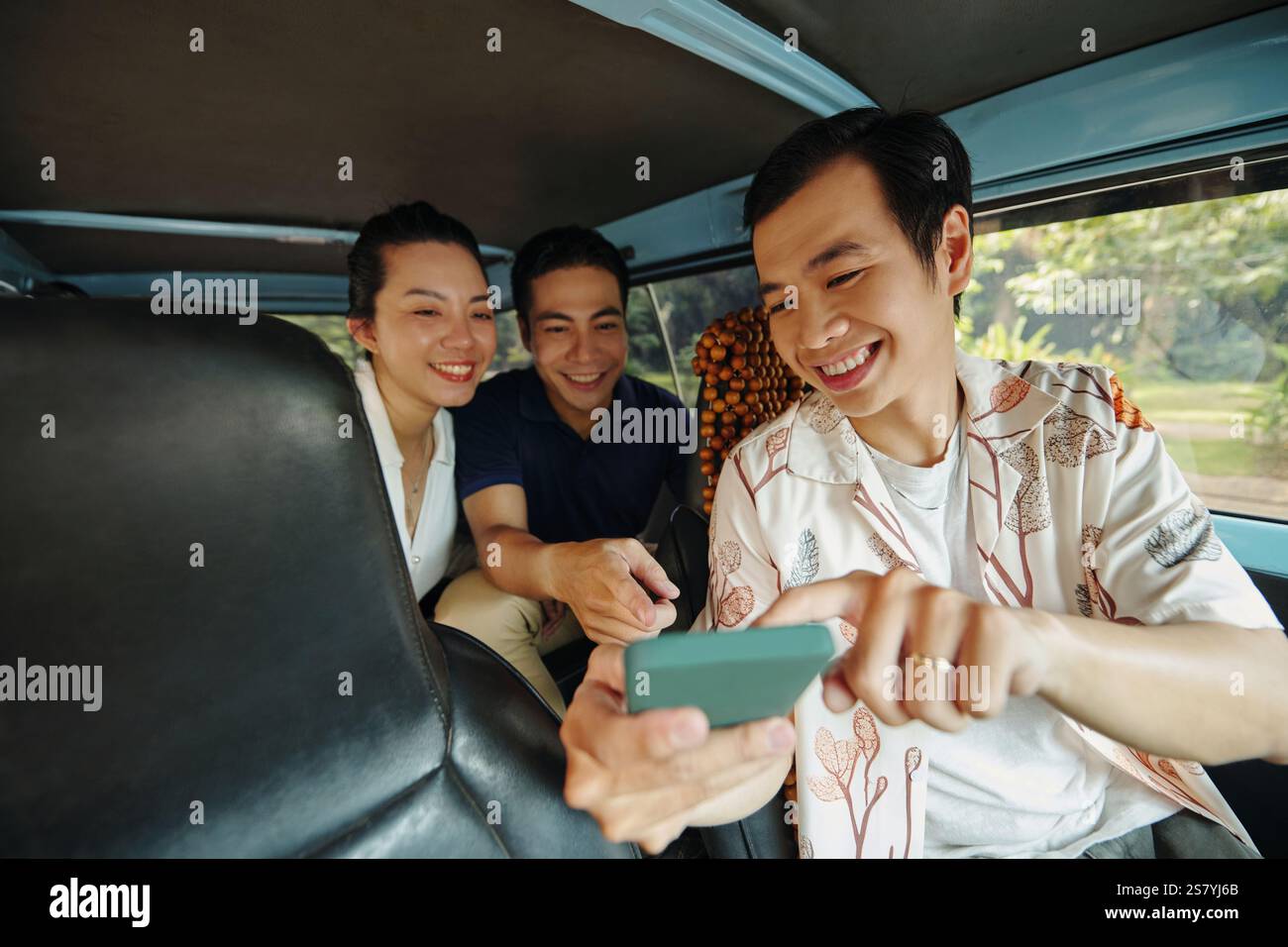 Friends Using GPS During Driving Stock Photo