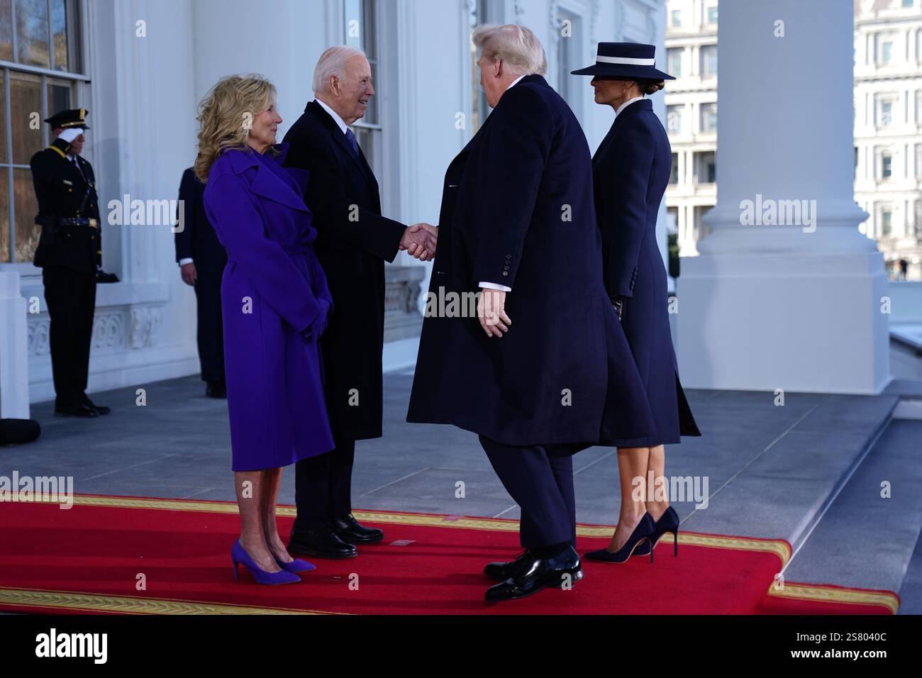 President Joe Biden (2L) and First Lady Dr. Jill Biden (L) greet