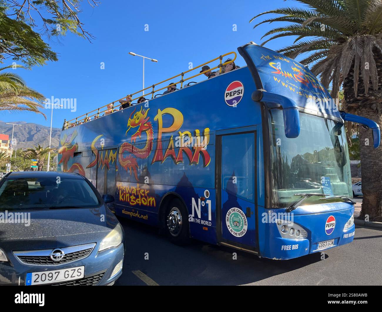 Siam Park Bus passing a parked car in Costa Adeje. Tenerife, Canary Islands, Spain. 11th January 2025. - Smartphone Captured Stock Image