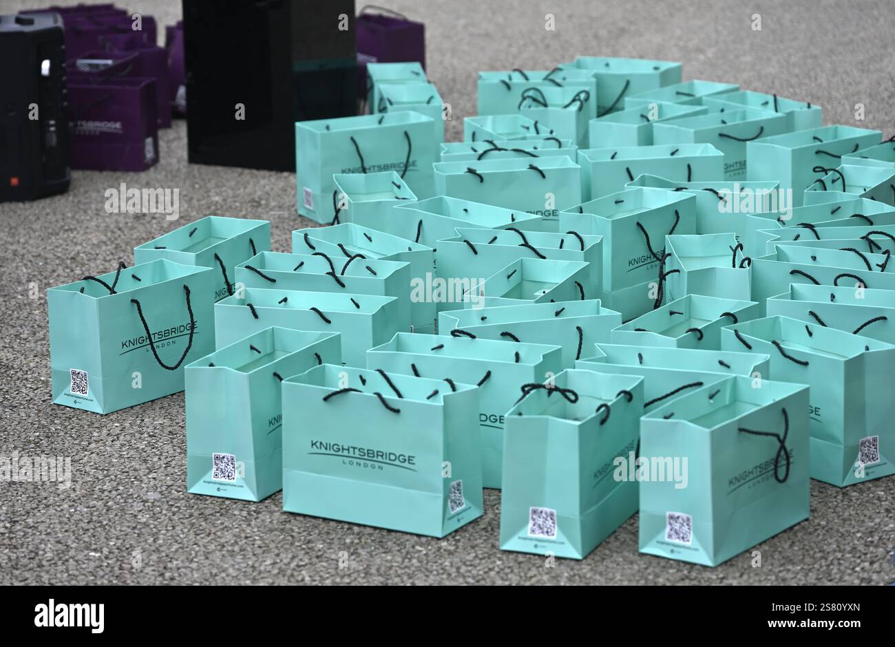 Layed Open Multiple colourful blue paper shopping bags, laid open on pavement ...