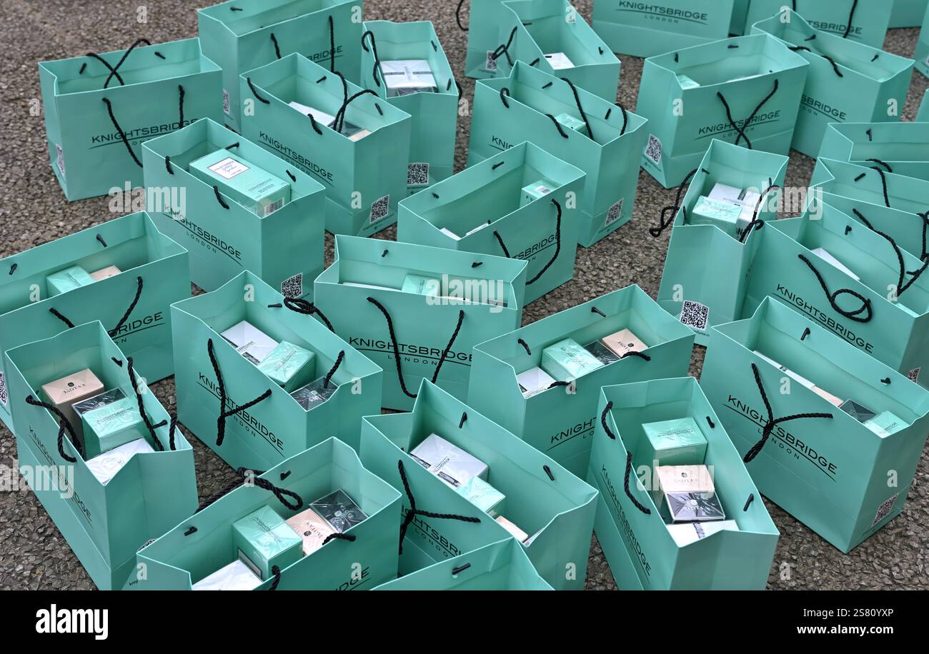 Layed Open Multiple colourful blue paper shopping bags, laid open on pavement ...