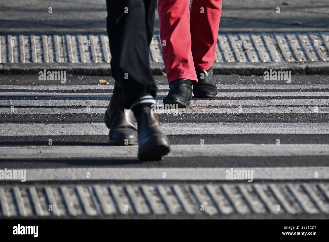 Berlin, Germany. 20th Jan, 2025. Pedestrians cross a crosswalk. Credit