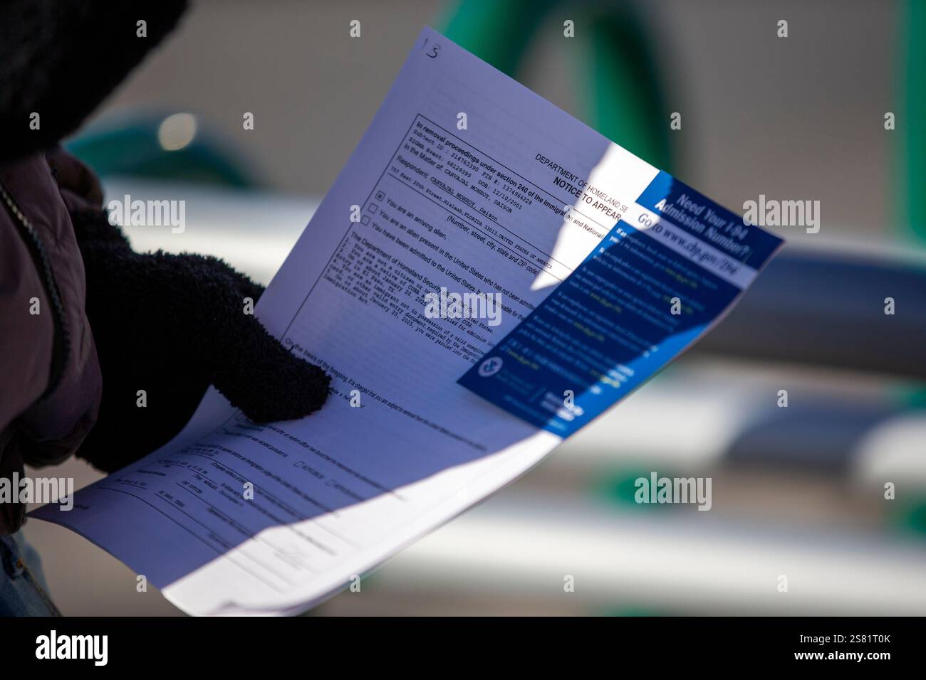 A migrant holds his immigration papers after entering the United States
