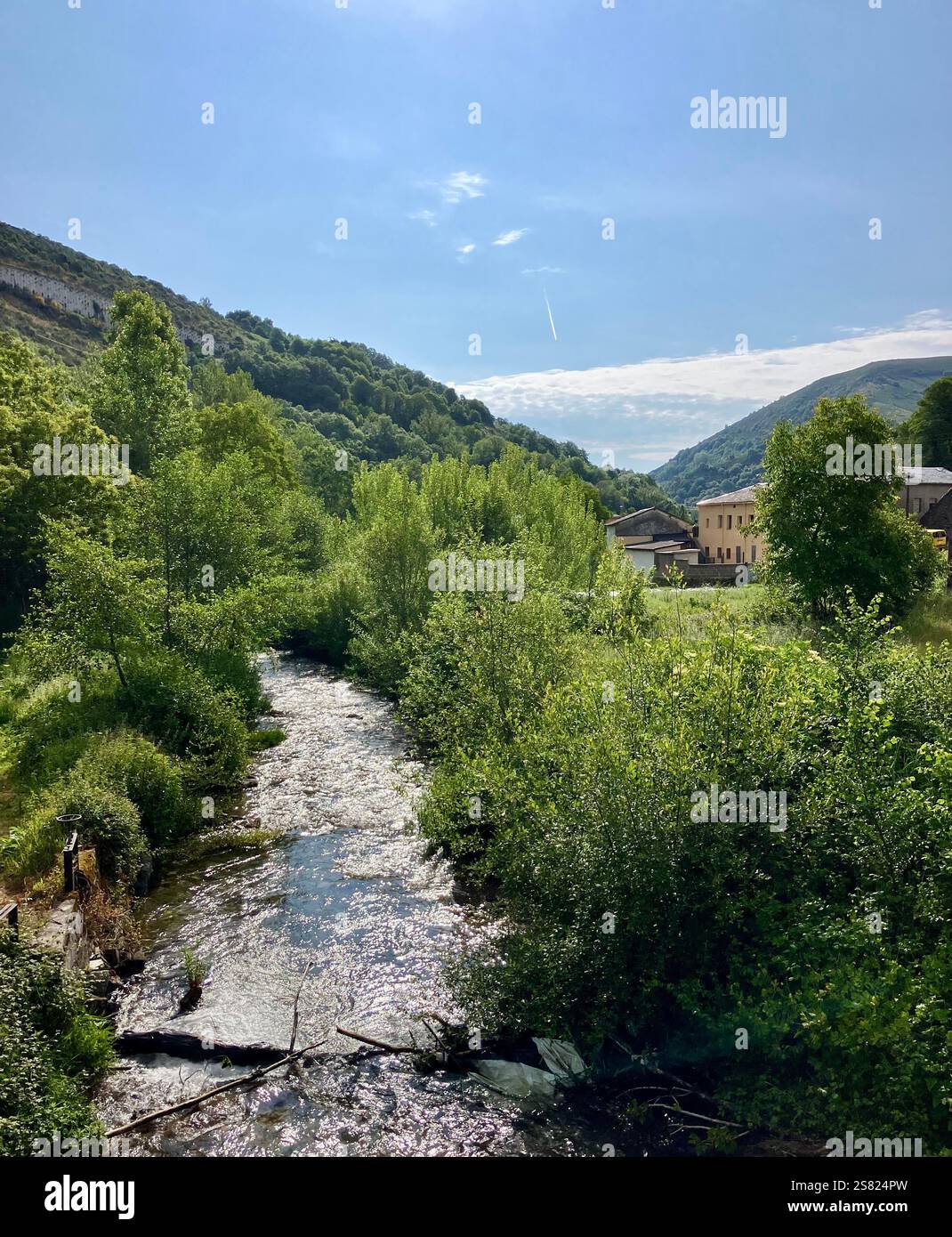 River in the Valley with Wooded Hillside, Blue Sky and an Old Buildiing in the Background - Smartphone Captured Stock Image