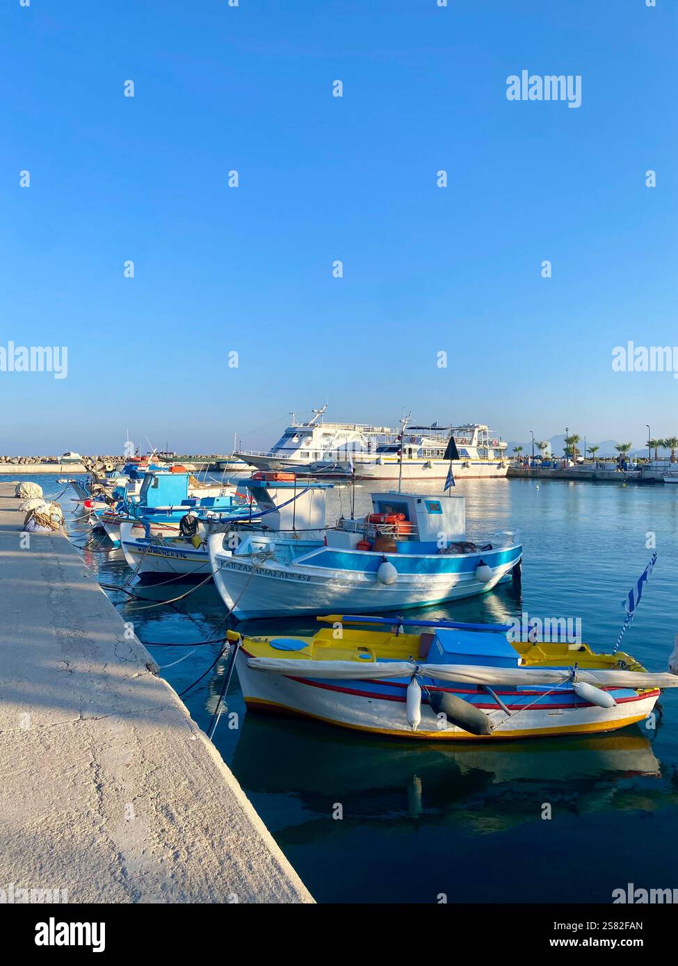 High angle view of boats moored at harbor against clear blue sky - Smartphone Captured Stock Image