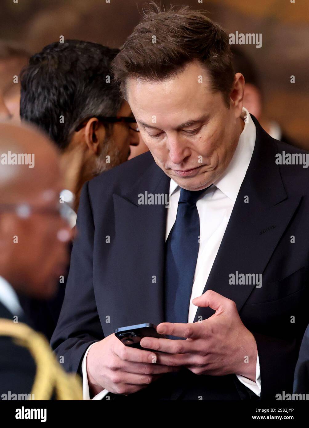 Elon Musk holds his phone on the day of the presidential inauguration