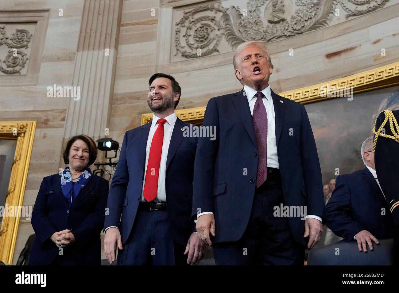 President Donald Trump, center, on stage with Vice President JD Vance ...