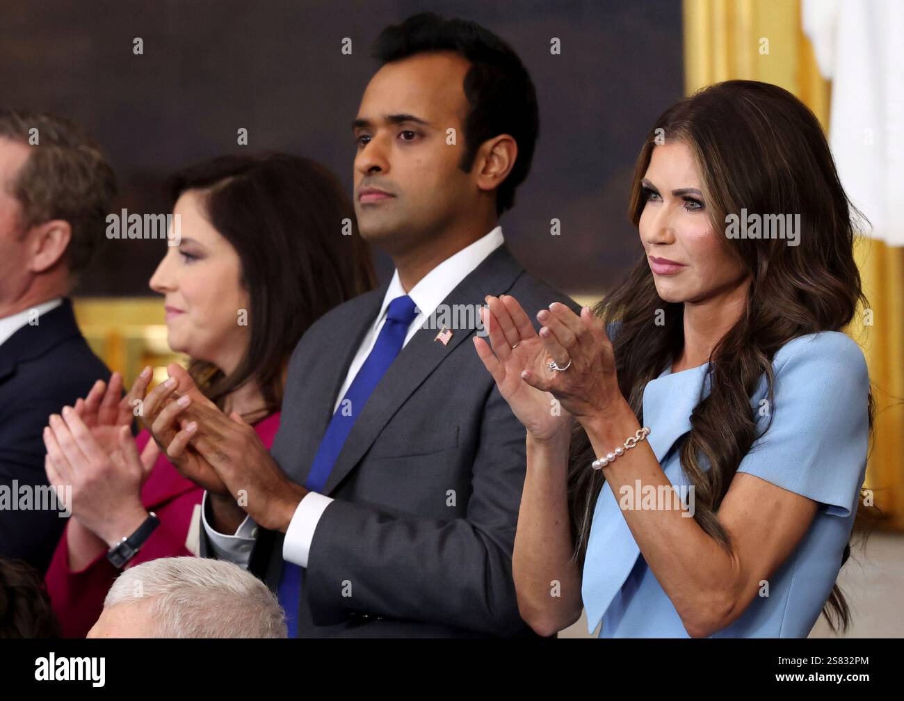 Vivek Ramaswamy and Kristi Noem applaud during U.S. President Donald