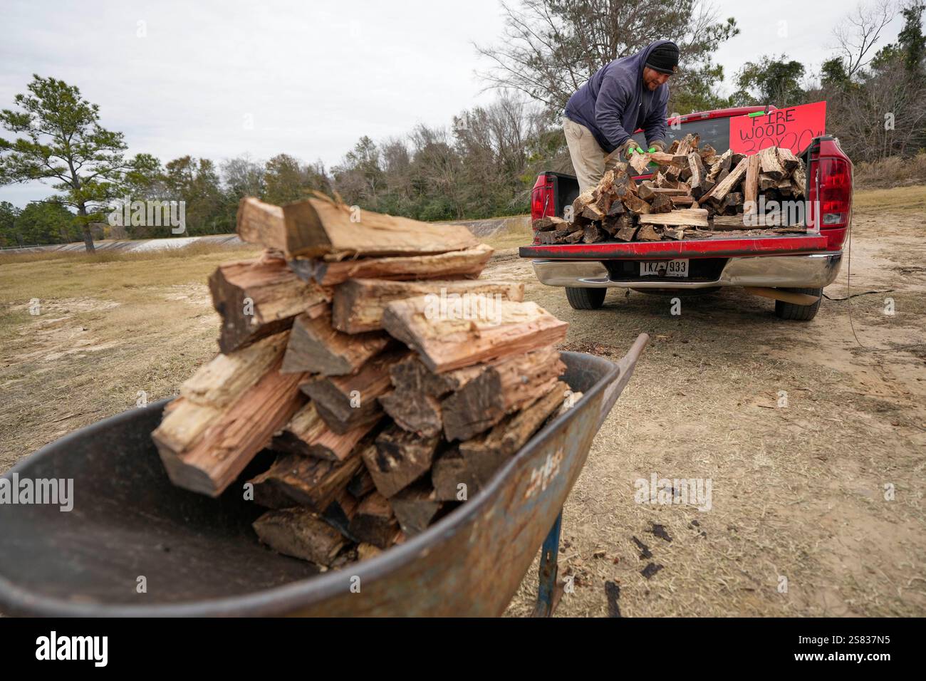 William Amaya gathers firewood for a customer Monday, Jan. 20, 2025, in