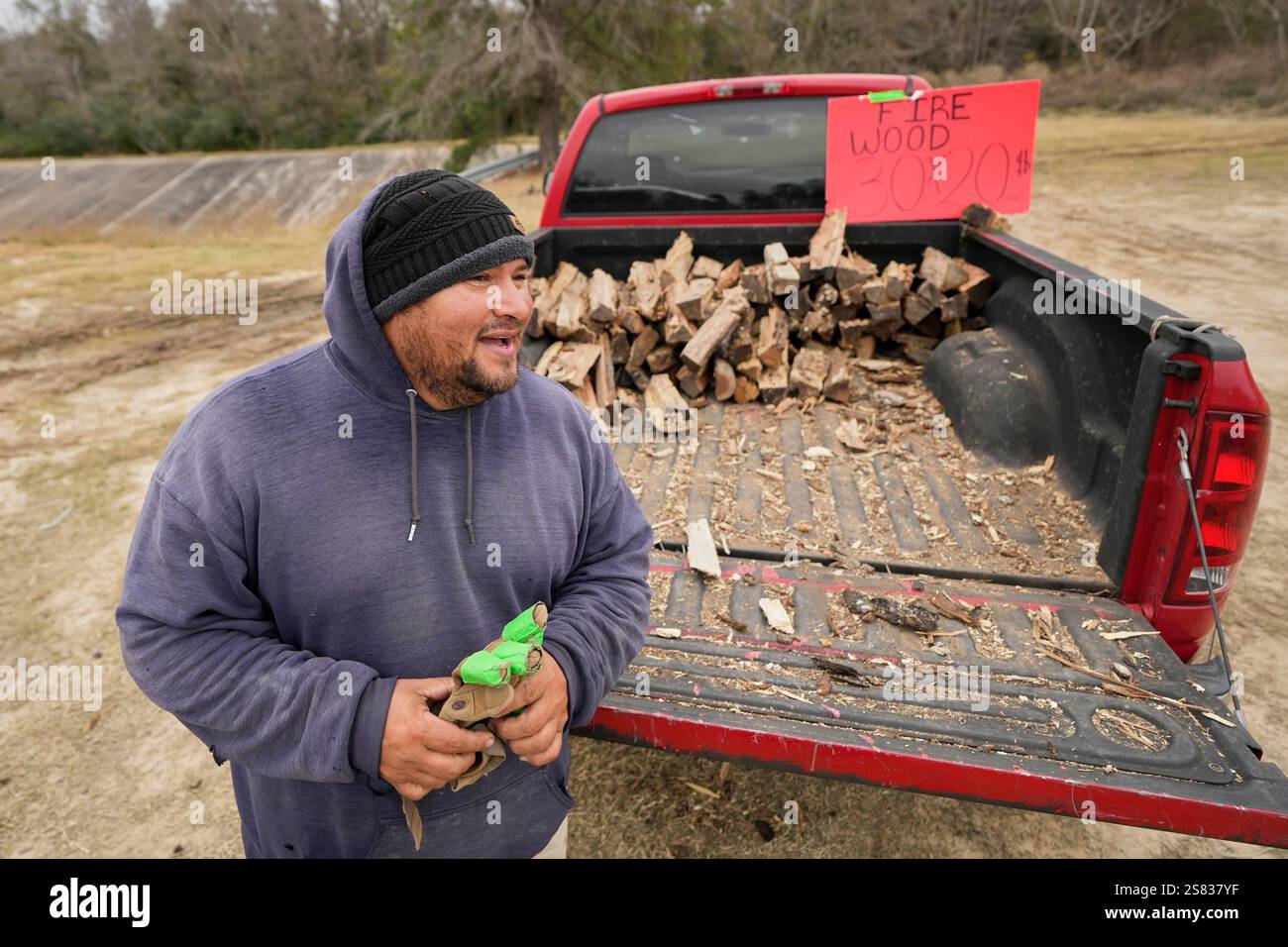 William Amaya sells firewood Monday, Jan. 20, 2025, in Houston, ahead