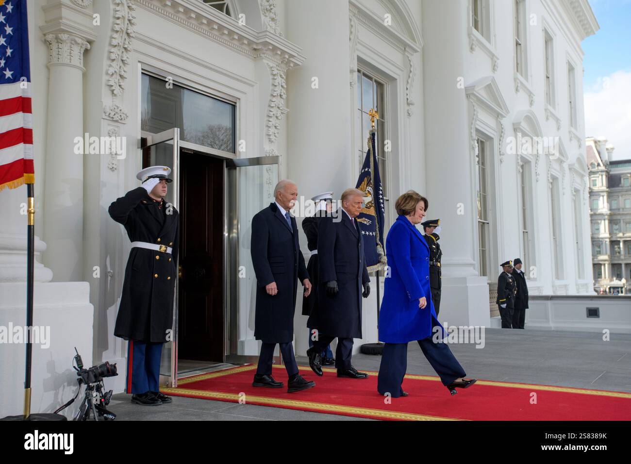 Sen. Amy Klobuchar, D-Minn.; President Joe Biden; and President-elect Donald Trump depart the