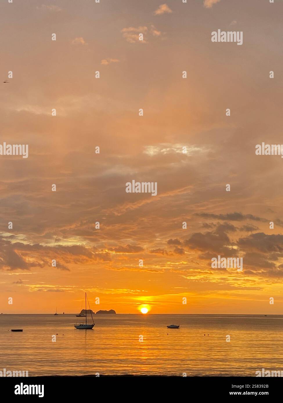Boats at sunset, Del Coco Beach, Costa Rica - Smartphone Captured Stock Image