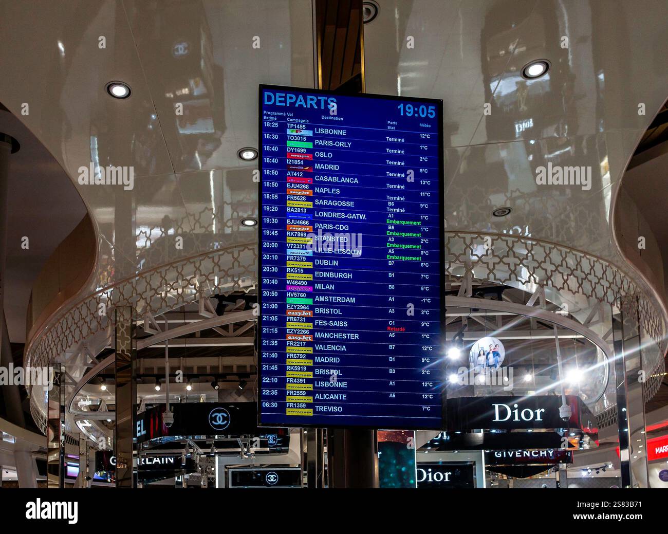 Departure notices for Marrakesh Menara International Airport, Morocco, showing departures to many destinations including Paris, Oslo and Milan. Stock Photo