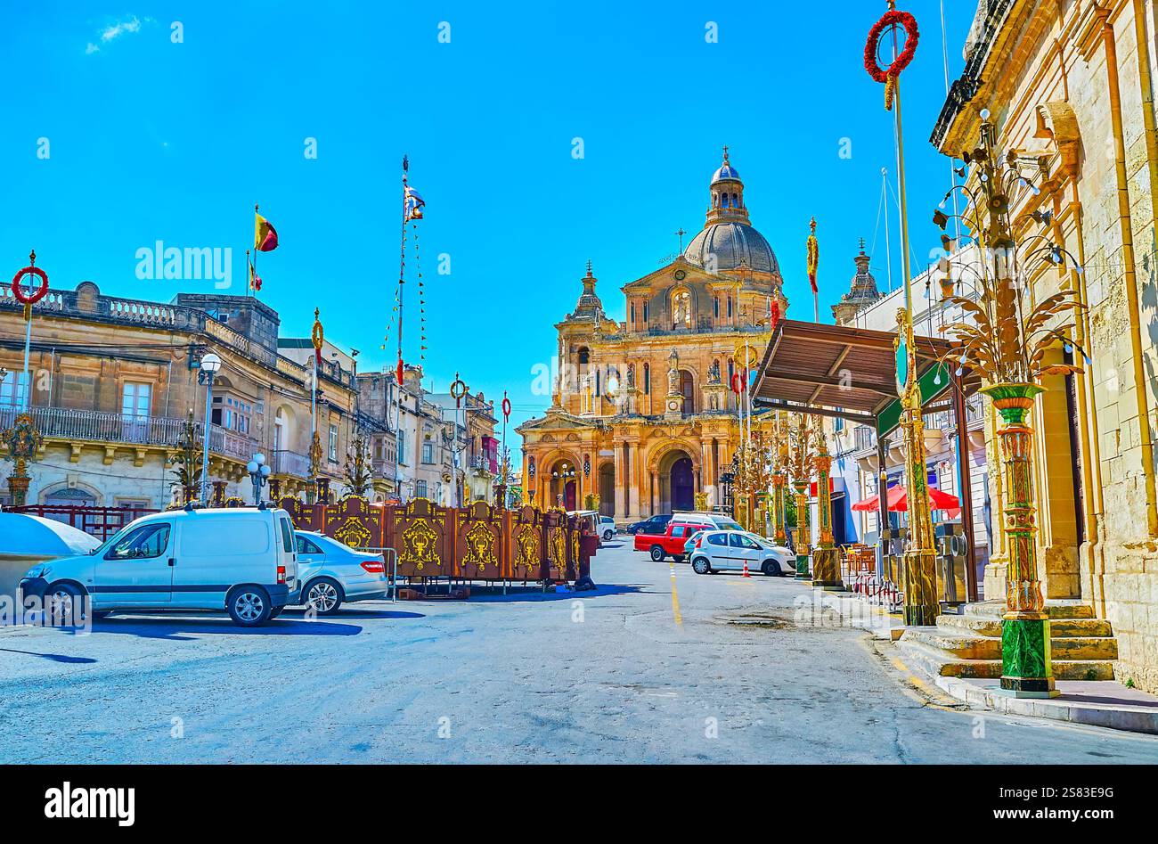 San Nichola street prepared to St Nicholas Feast - Parish church and roadside area decorated with garlands, flags, flower-lanterns and wreaths, Siggie Stock Photo