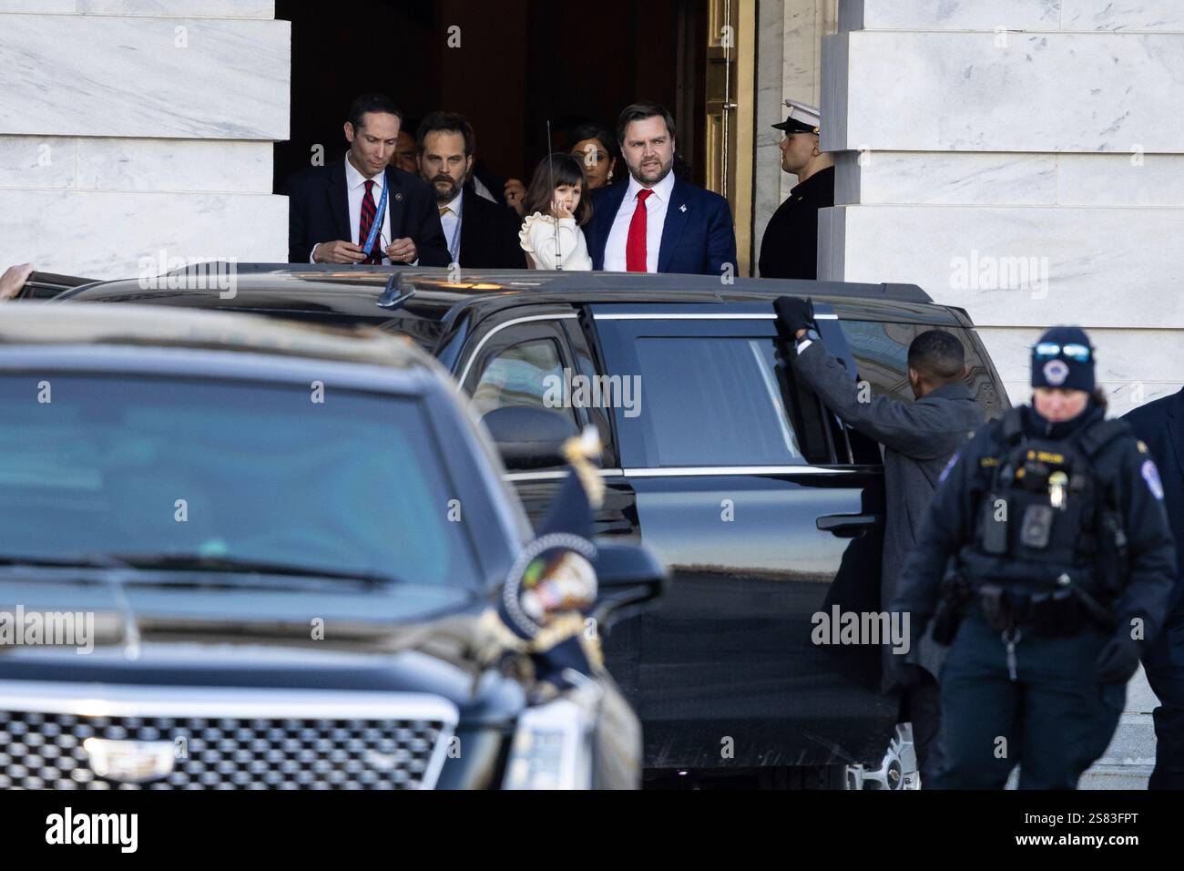 Vice President JD Vance holds his daughter, Mirabel, as he emerges from