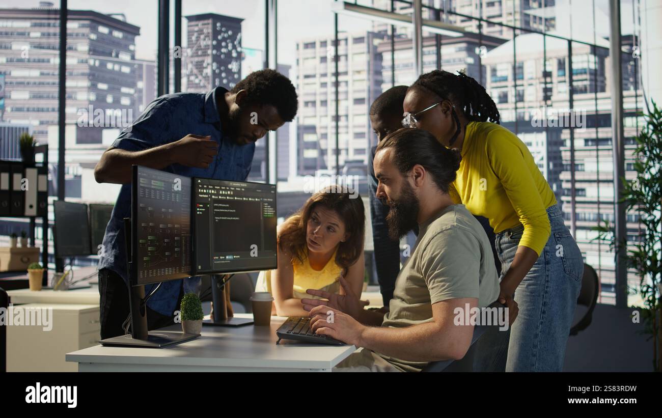 Programmers gathered together to conduct code review to fix errors, identifying technical issues with company software. Team of developers doing brainstorming, optimizing code, camera B Stock Photo
