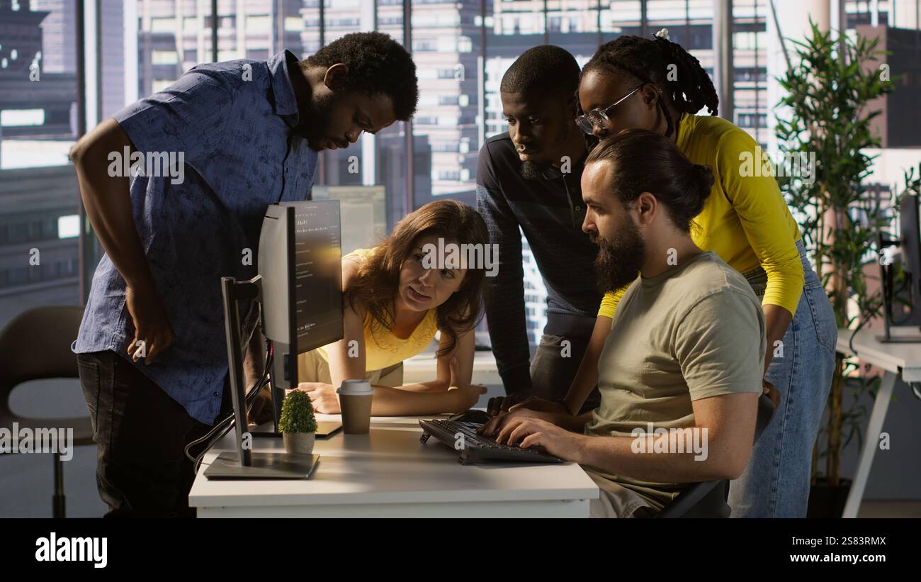 Programmers gathered together to conduct code review to fix errors, identifying technical issues with company software. Team of developers doing brainstorming, optimizing code, camera A Stock Photo