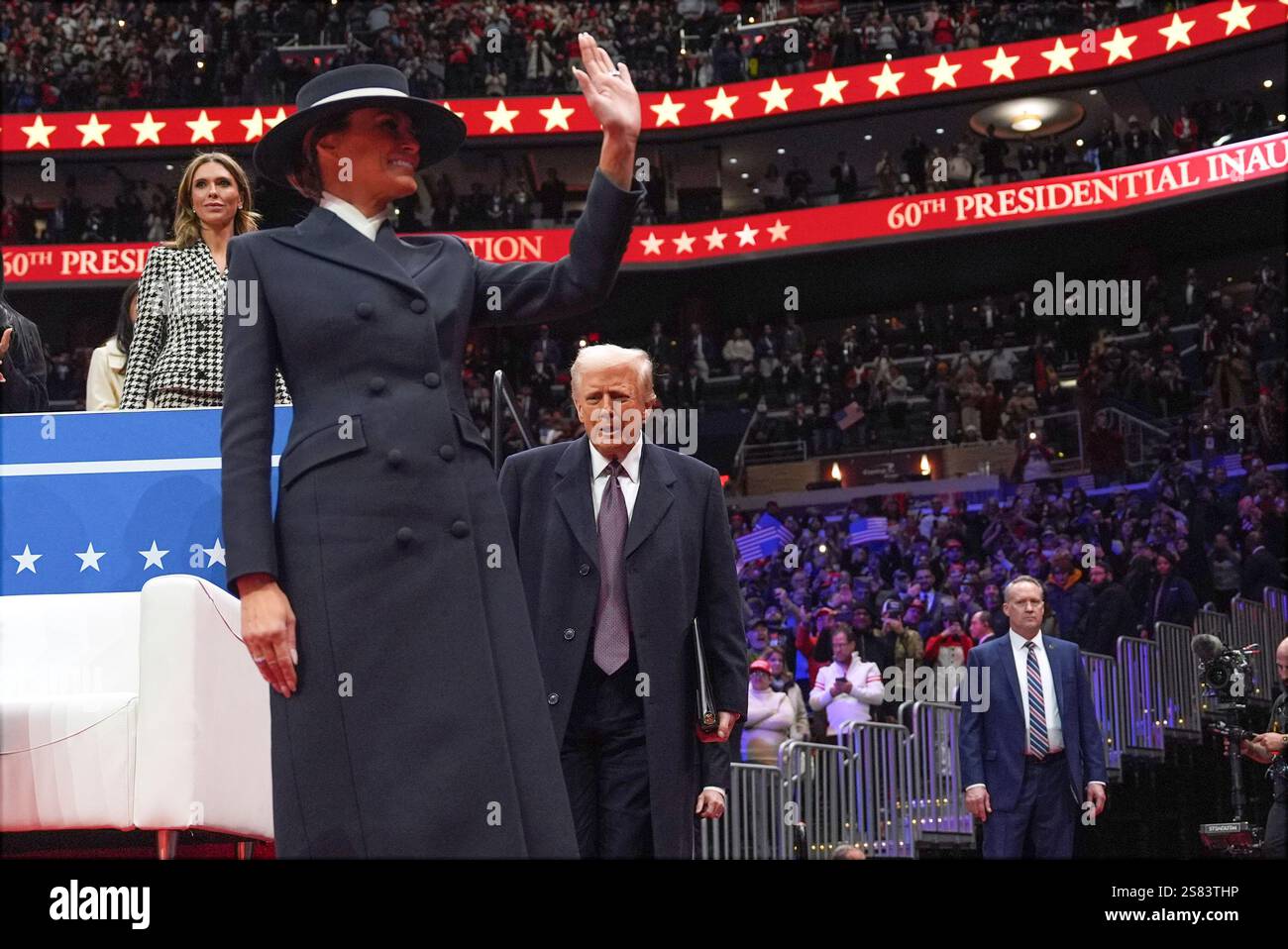 President Donald Trump and first lady Melania Trump arrive at an indoor