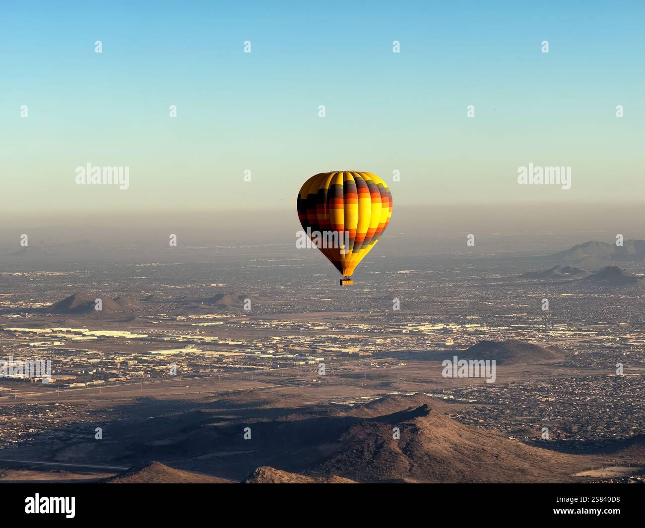 Aerial view of single hot air balloon in flight showing panoramic view of Phoenix Arizona during nice winter season day Stock Photo