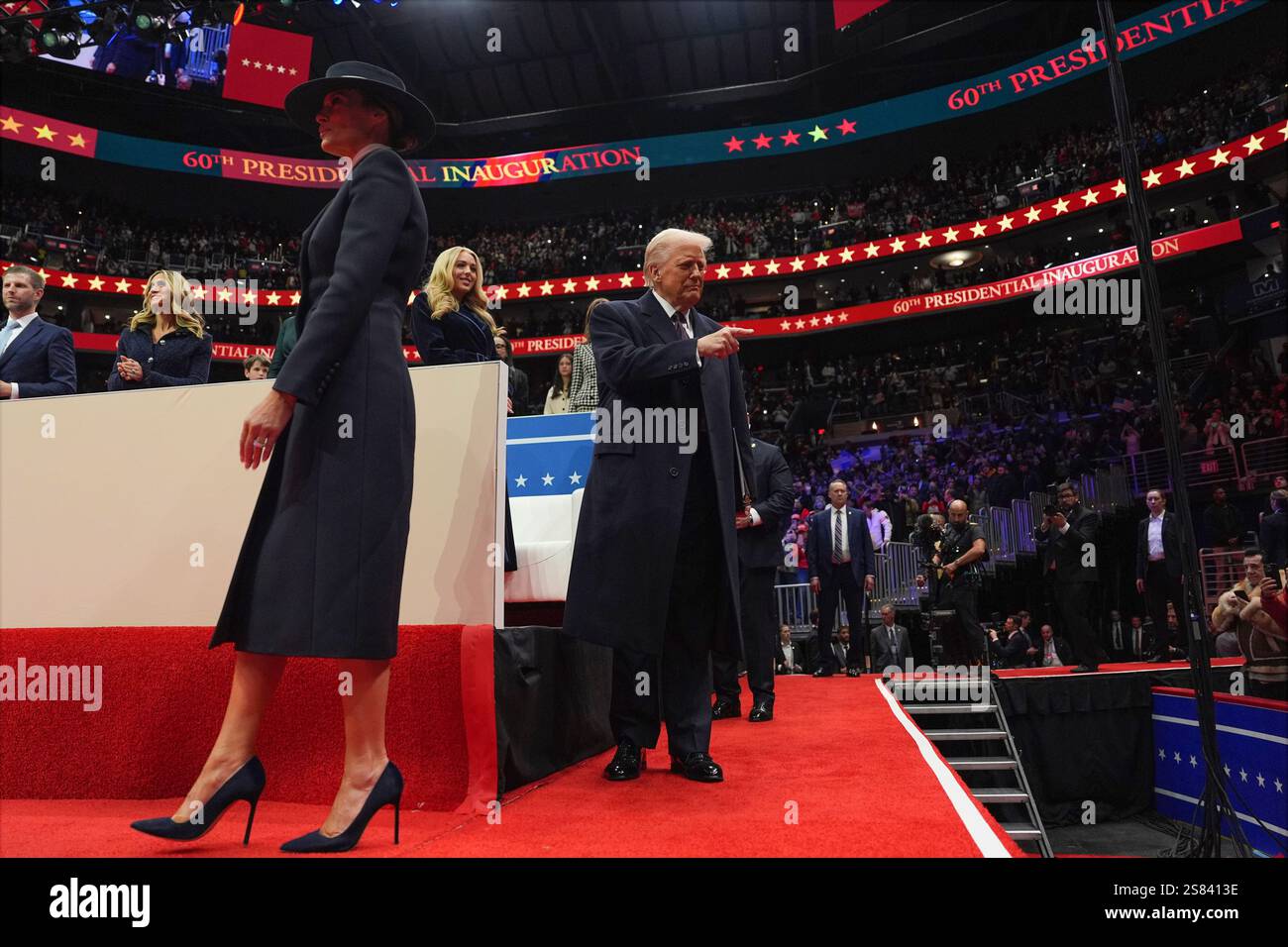 President Donald Trump and first lady Melania Trump arrive at an indoor