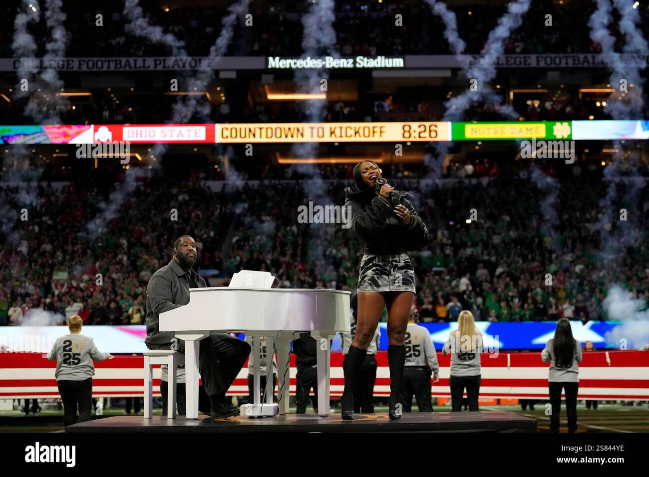 Coco Jones performs the national anthem before the College Football