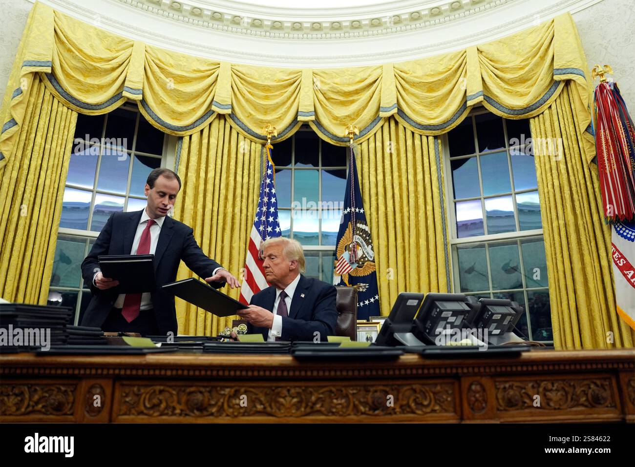 President Donald Trump signs executive orders in the Oval Office of the
