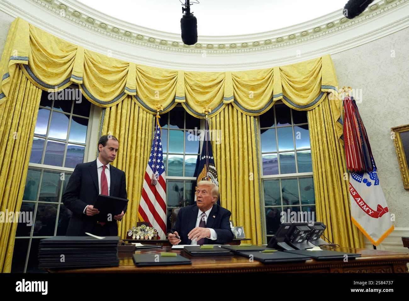 President Donald Trump signs executive orders in the Oval Office of the