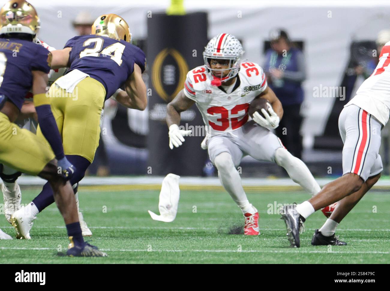 Ohio State running back TreVeyon Henderson (32) rushes for a short gain