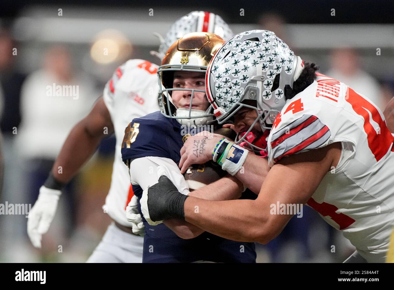 Notre Dame quarterback Riley Leonard is tackled by Ohio State defensive ...