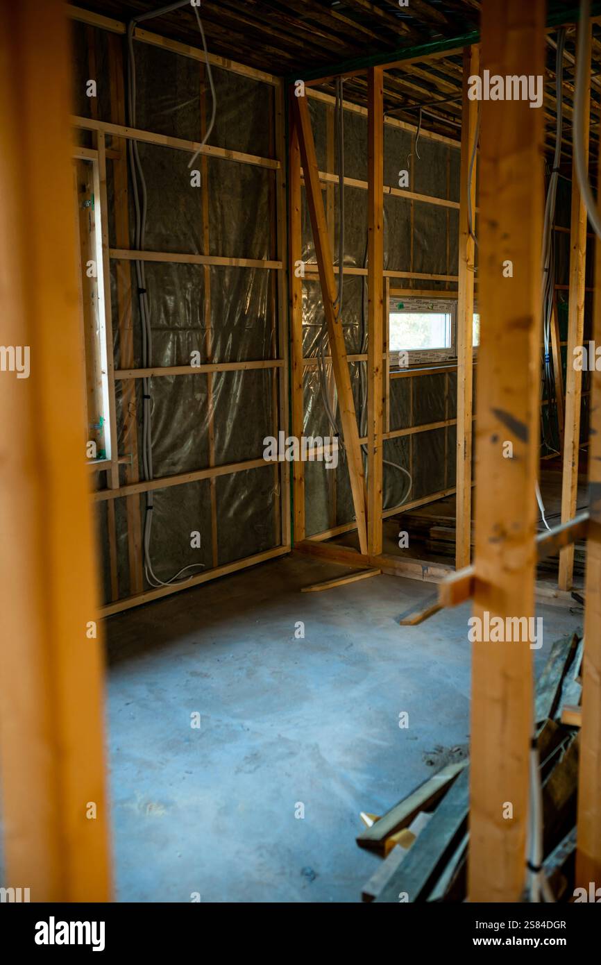 Unfinished building interior featuring exposed wooden framing, partial
