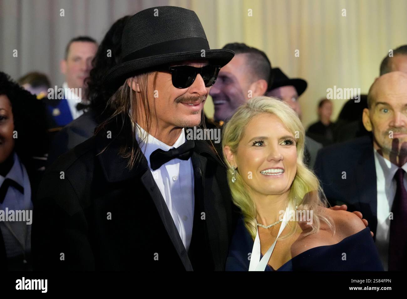 Kid rock, left, poses with an attendee at the Commander in Chief Ball