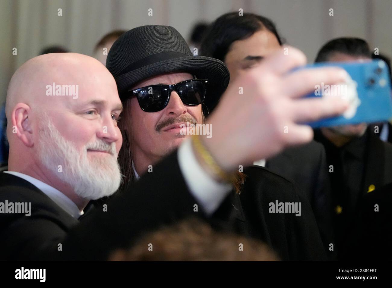 Kid rock, right, poses with an attendee at the Commander in Chief Ball