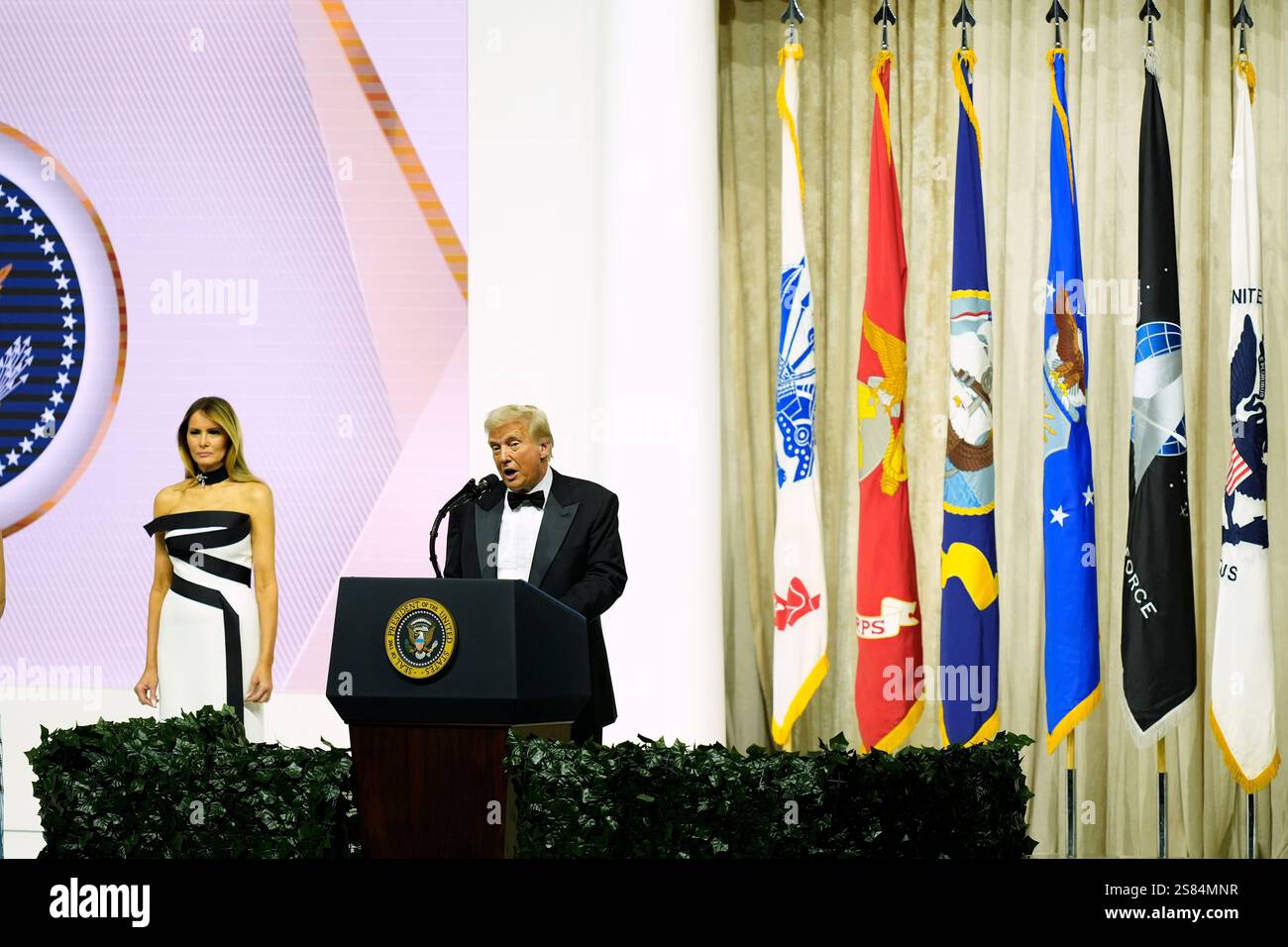 President Donald Trump speaks as first lady Melania Trump listens at
