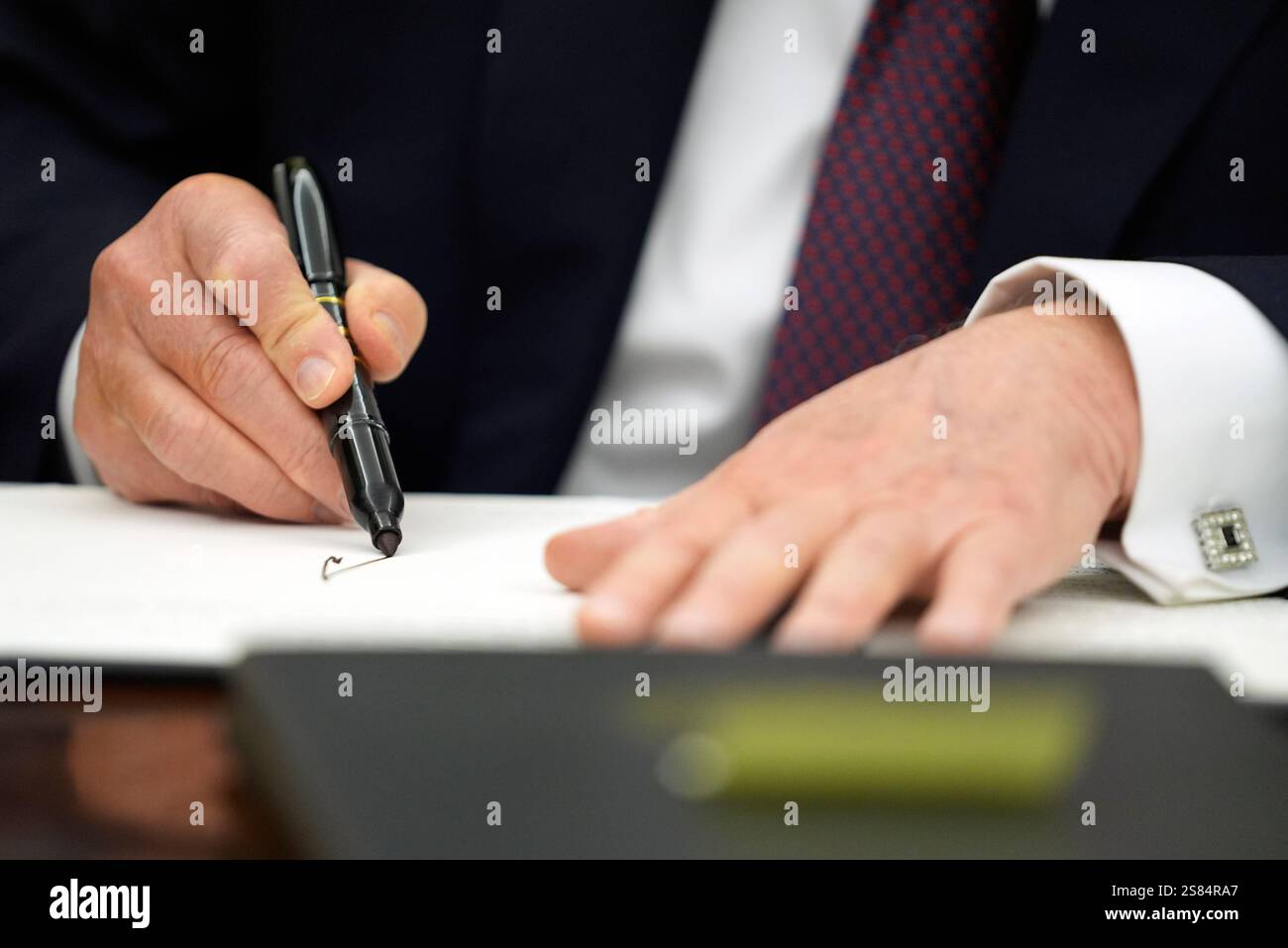 President Donald Trump signs executive orders in the Oval Office of the