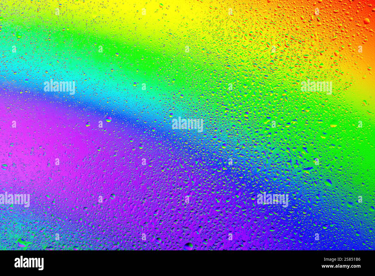 Colorful droplets create a stunning rainbow effect on a misty surface ...