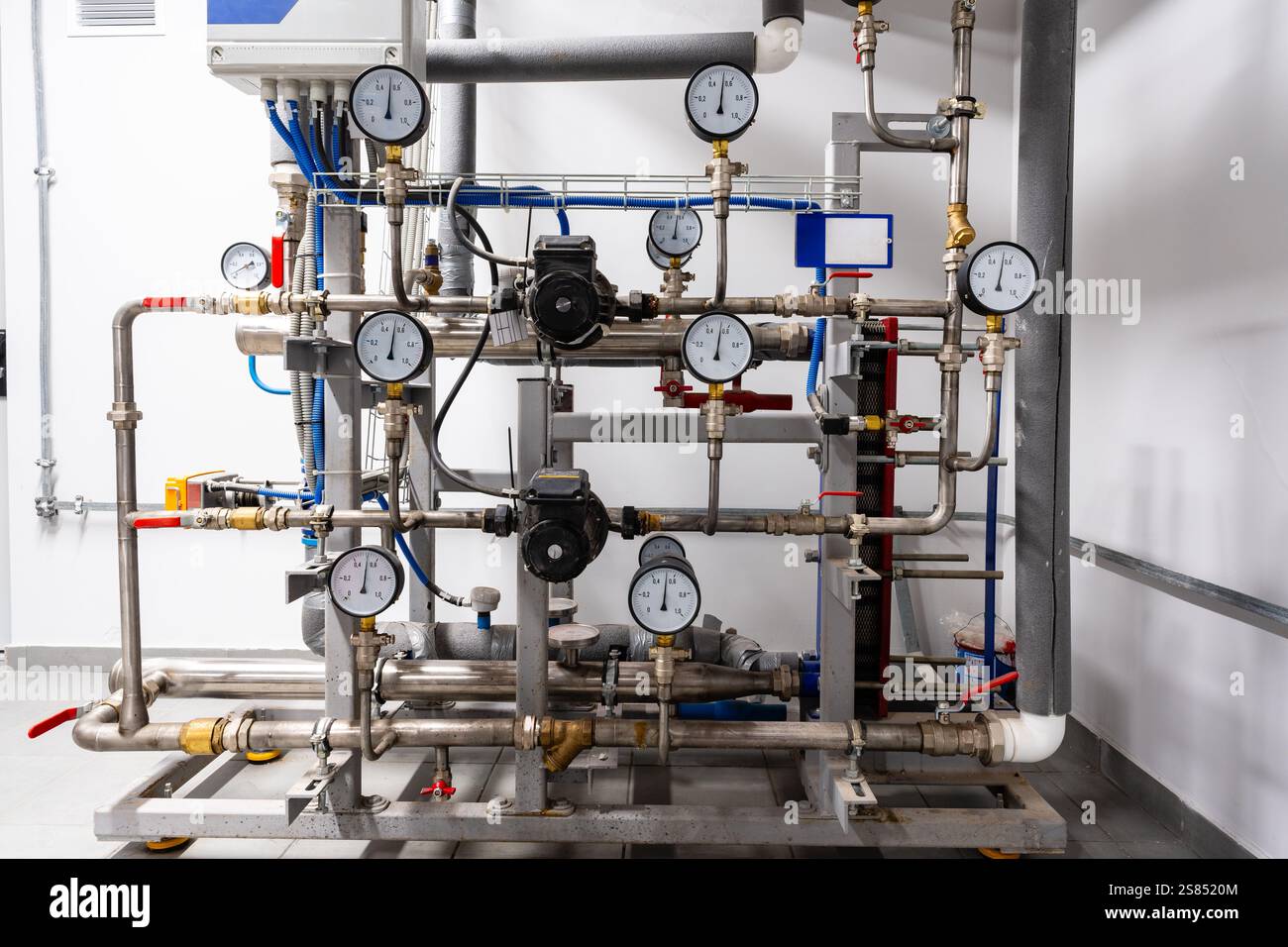 Complex industrial piping system with pressure gauges in a modern ...
