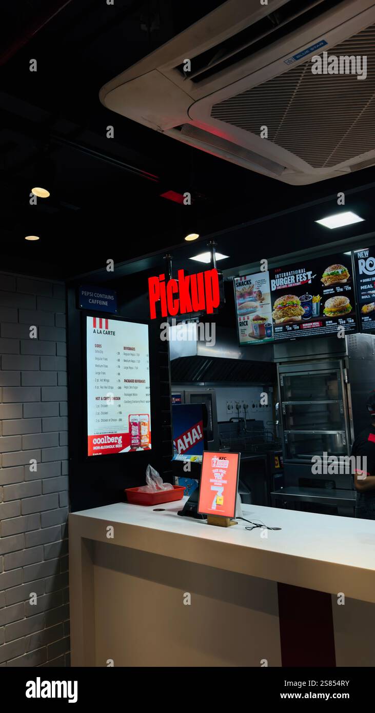 This image showcases a vibrant fast-food pickup counter, with a bold red 'Pickup' sign glowing under modern ceiling lights. - Smartphone Captured Stock Image