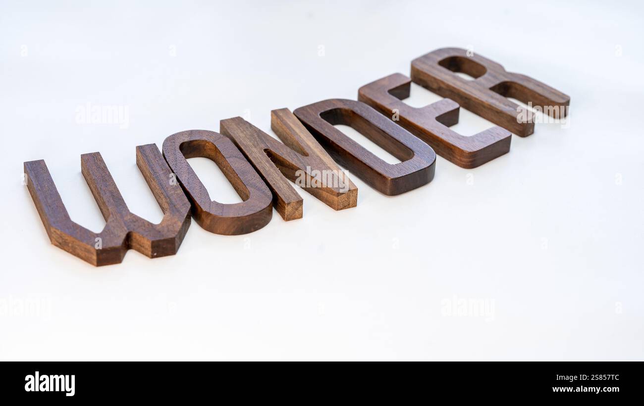 Wonder Unveiled: Awe and Curiosity in Wooden Letters Stock Photo - Alamy