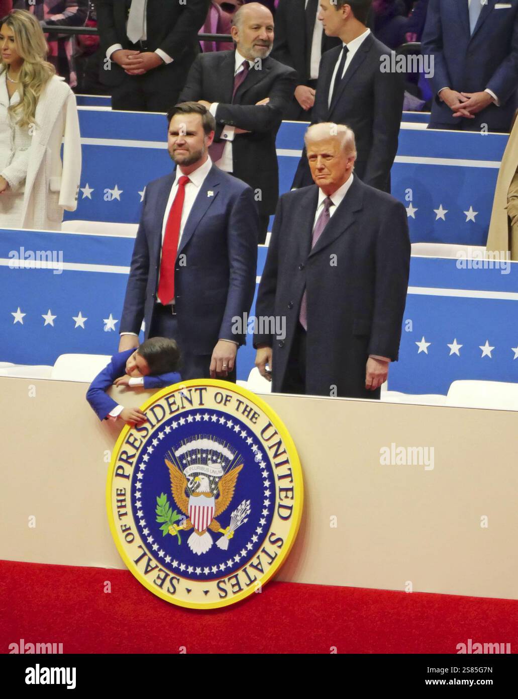 U.S. President Donald Trump (R) appears in front of his supporters in