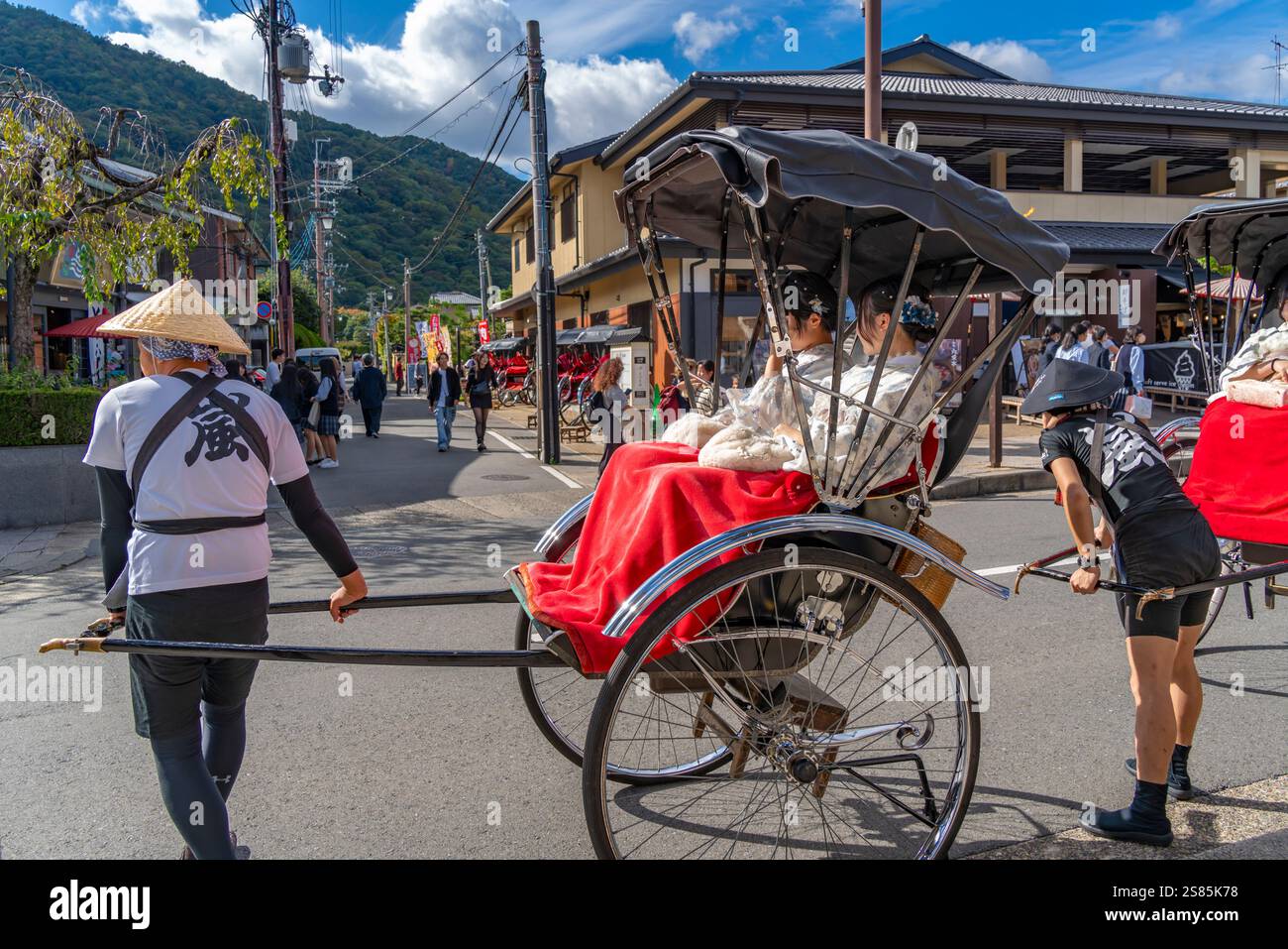 View of rickshaws near Togetsukyo Bridge over Katsura River, Sagatenryuji Susukinobabacho, Ukyo Ward, Kyoto, Honshu, Japan Stock Photo