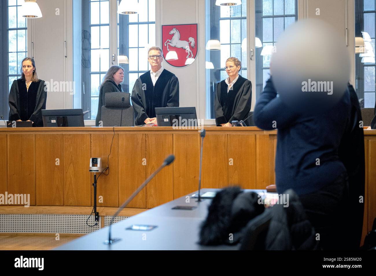 21 January 2025, Lower Saxony, Oldenburg The defendant (r) stands in