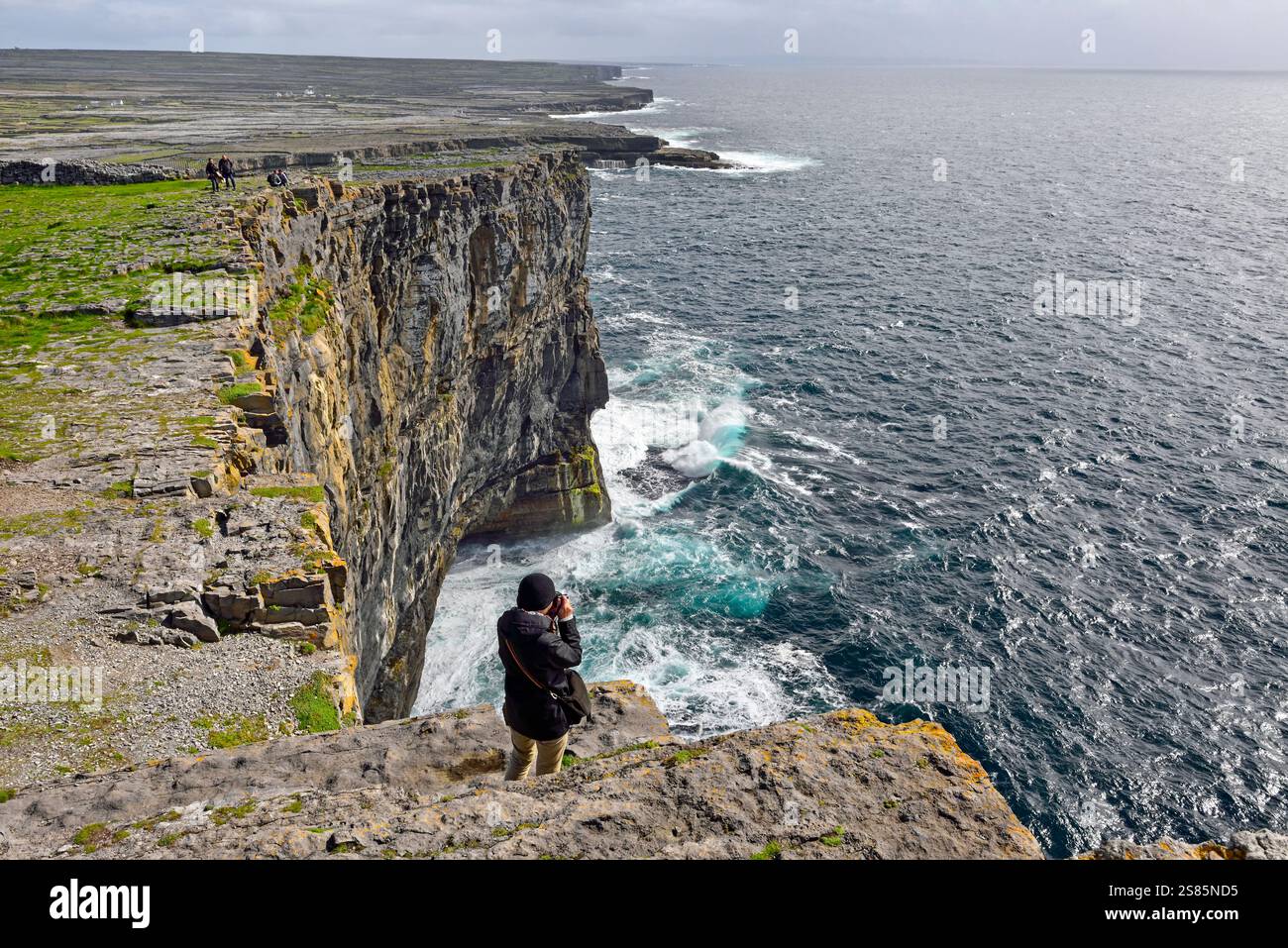 Taking photo of cliffs from Dun Aengus, prehistoric hill fort ...