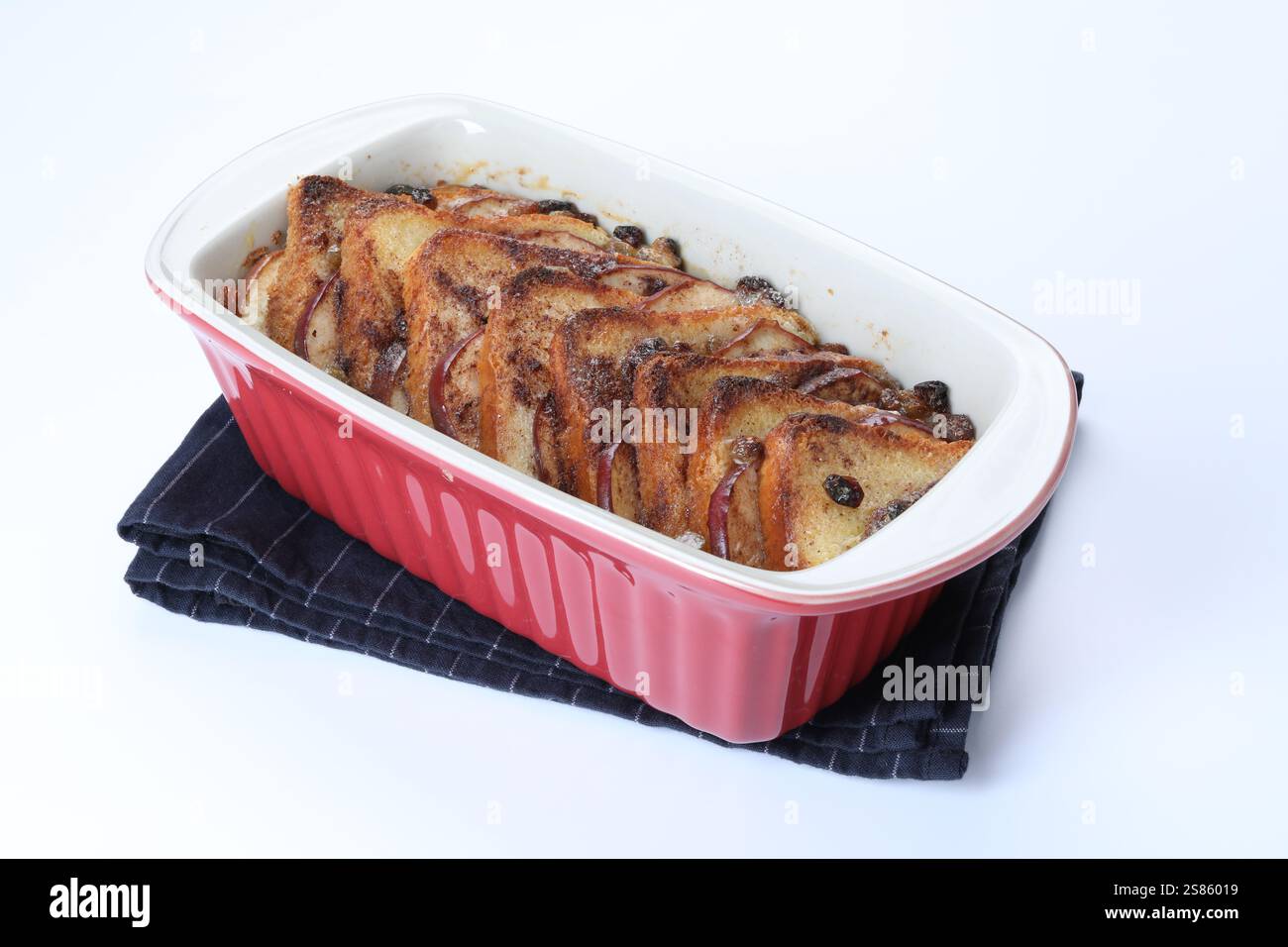 Delicious bread pudding in baking dish isolated on white Stock Photo