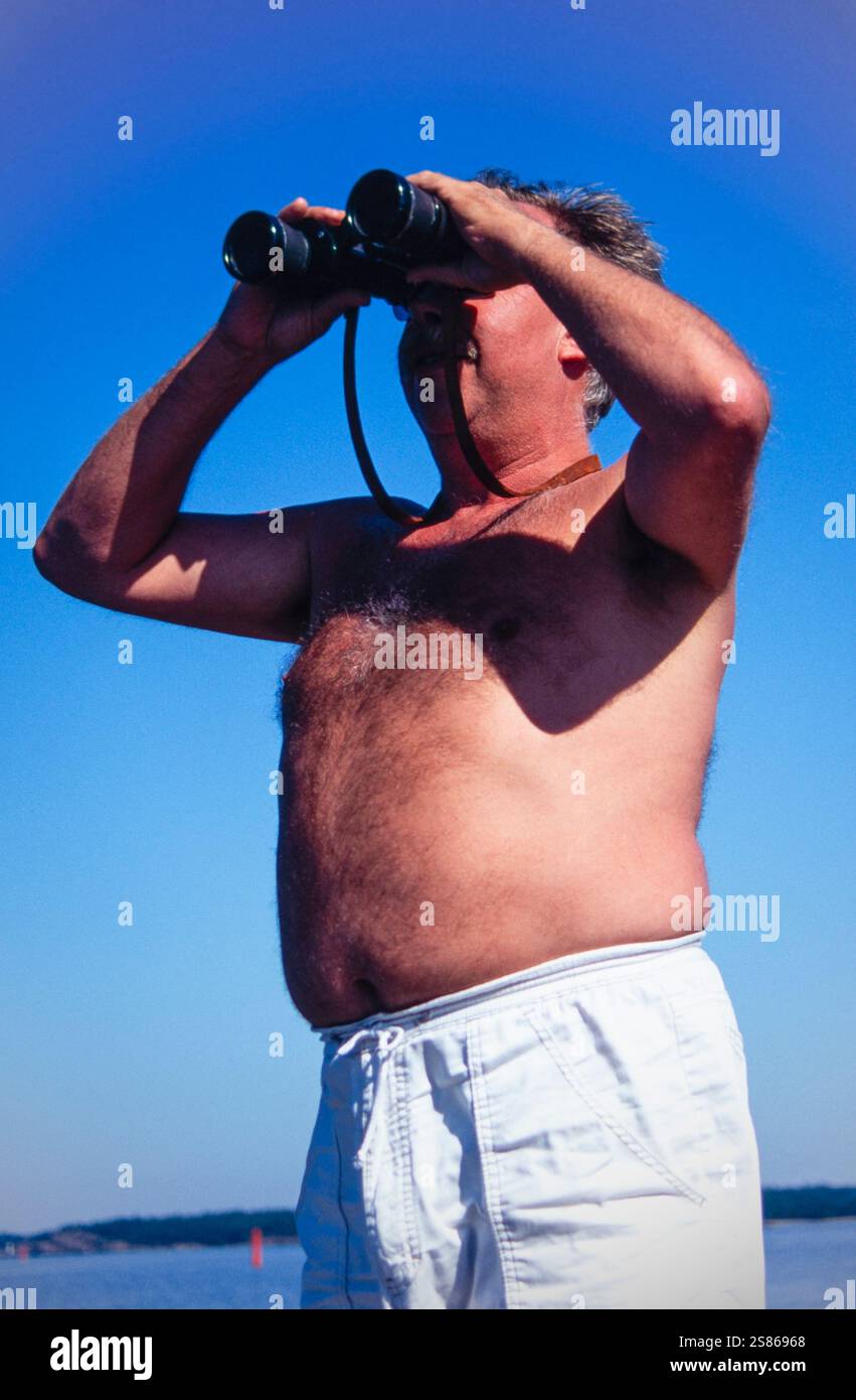 Man with binoculars Stock Photo