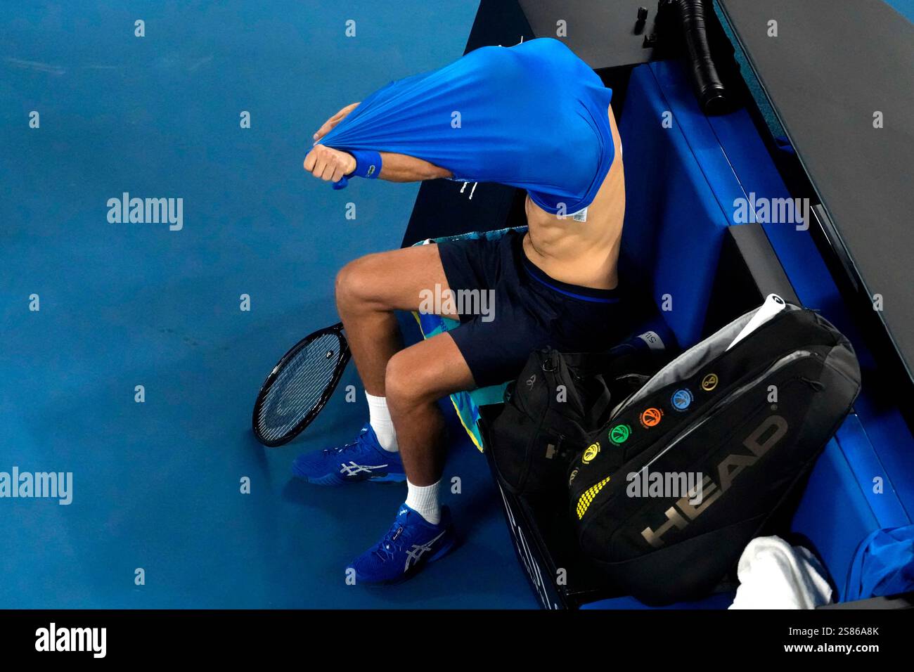 Novak Djokovic of Serbia takes his shirt off during his quarterfinal