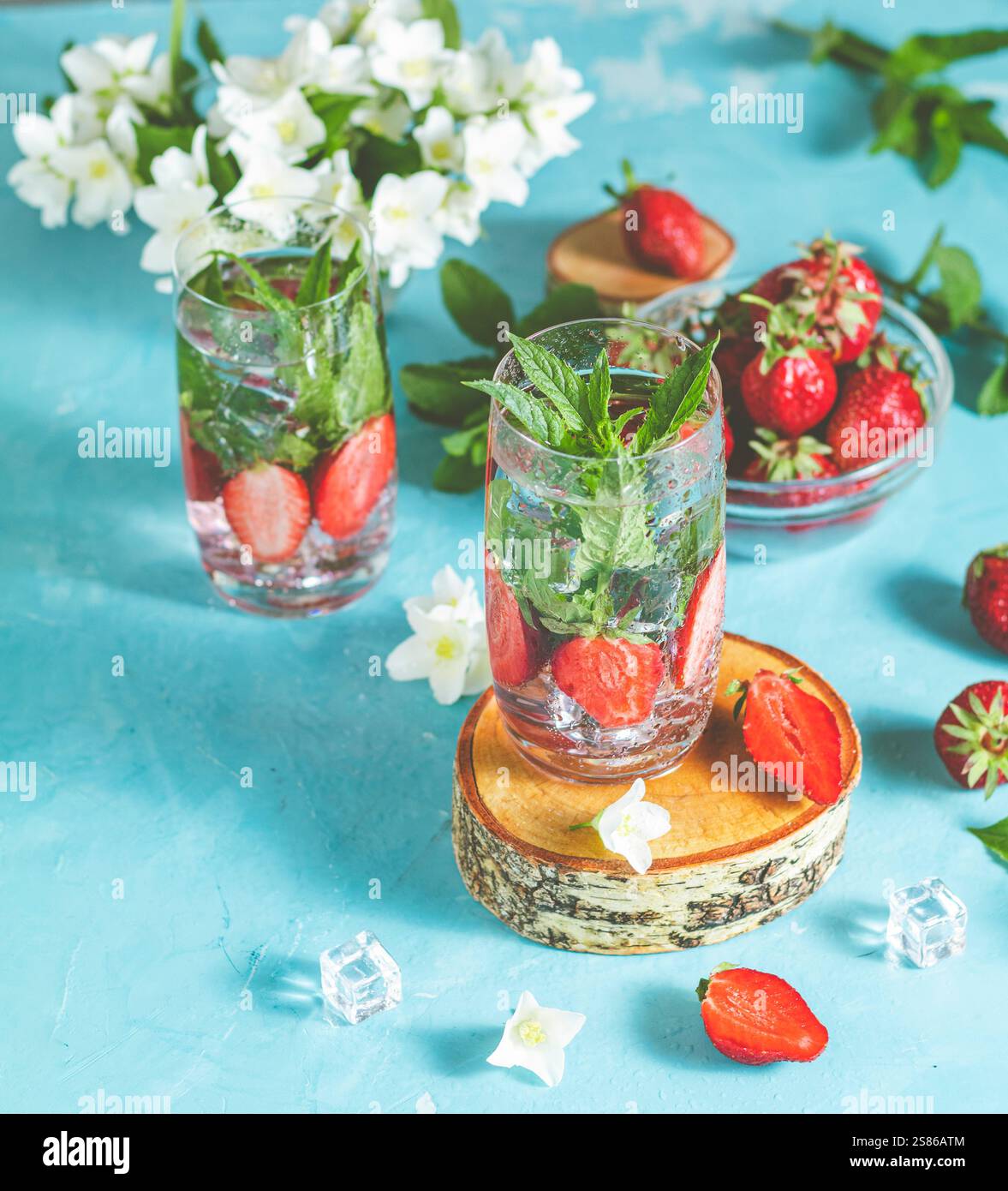 Two glasses of refreshing infused water with fresh strawberries and ...
